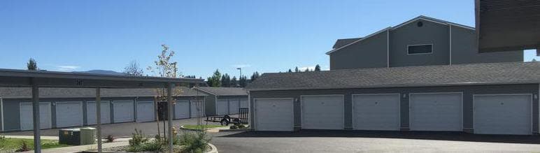 Detached garage building with a full row of insulated steel doors at a multi-family property